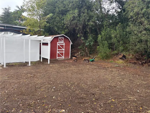 a view of a wooden house with a yard