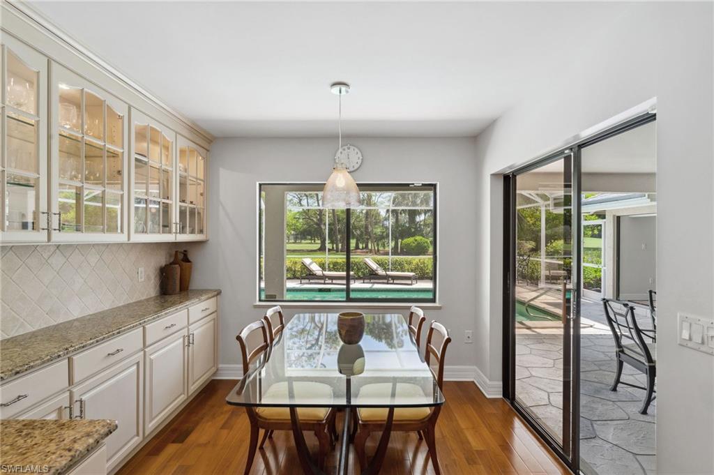 1986 Imperial Golf Course Boulevard Naples, FL 34110 - Photo 11 of 38 a view of a kitchen area with furniture and large windows