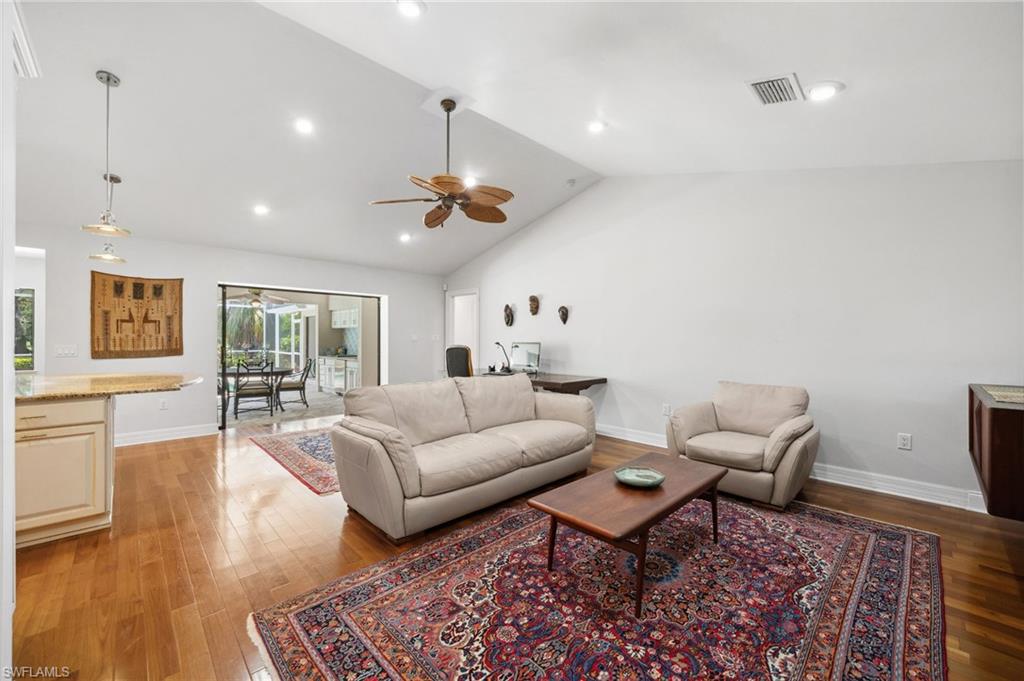 1986 Imperial Golf Course Boulevard Naples, FL 34110 - Photo 15 of 38 a living room with furniture and wooden floor