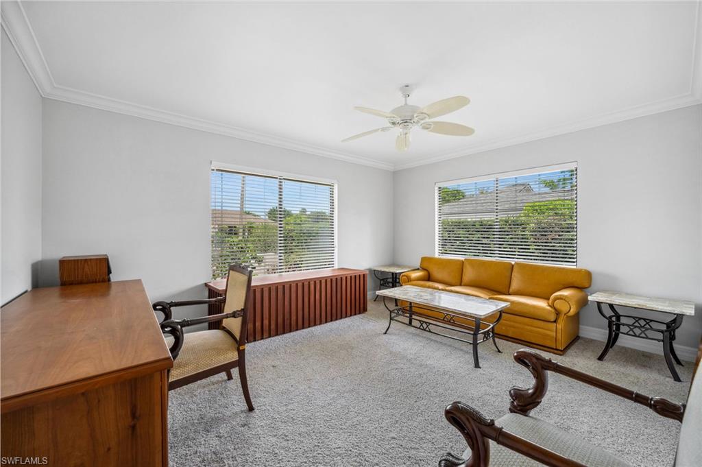 1986 Imperial Golf Course Boulevard Naples, FL 34110 - Photo 20 of 38 a living room with furniture and a window