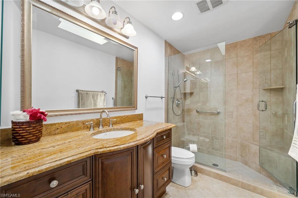 1986 Imperial Golf Course Boulevard Naples, FL 34110 - Photo 21 of 38 a bathroom with a sink a toilet and shower