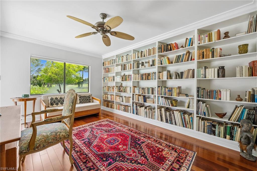 1986 Imperial Golf Course Boulevard Naples, FL 34110 - Photo 25 of 38 a living room with furniture and a book shelf