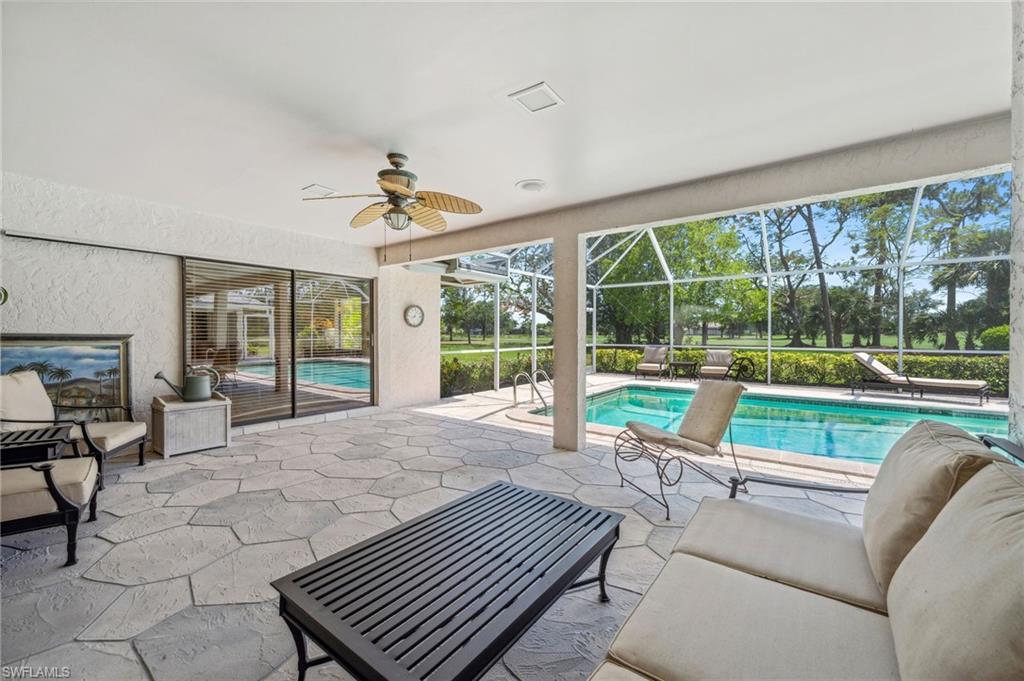 1986 Imperial Golf Course Boulevard Naples, FL 34110 - Photo 27 of 38 a living room with furniture and a floor to ceiling window