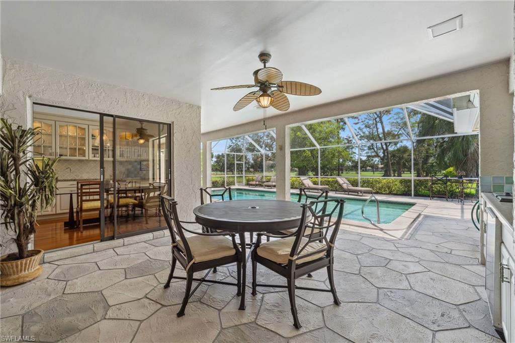 1986 Imperial Golf Course Boulevard Naples, FL 34110 - Photo 29 of 38 a dining room with furniture and a floor to ceiling window