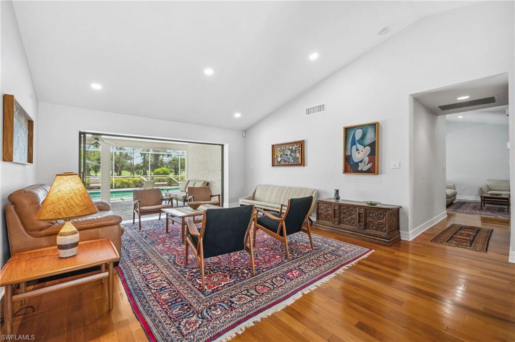 1986 Imperial Golf Course Boulevard Naples, FL 34110 - Photo 4 of 38 a living room with furniture a rug and a large window