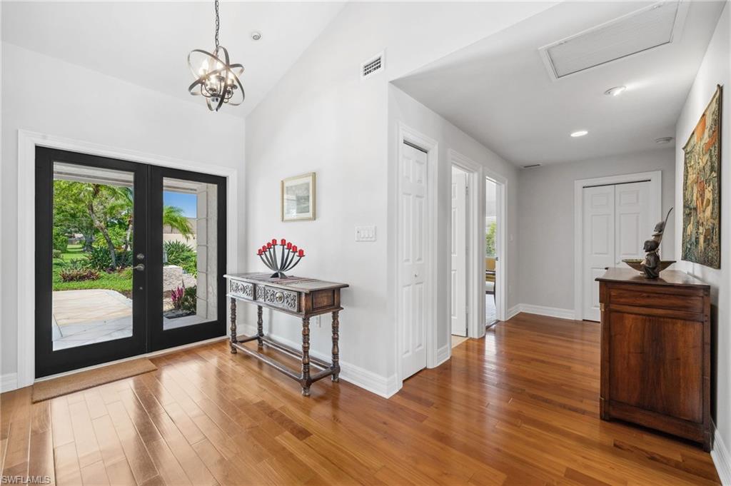 1986 Imperial Golf Course Boulevard Naples, FL 34110 - Photo 5 of 38 a work room with wooden floor and furniture