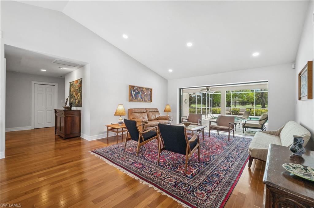 1986 Imperial Golf Course Boulevard Naples, FL 34110 - Photo 8 of 38 a living room with furniture a large window and a table