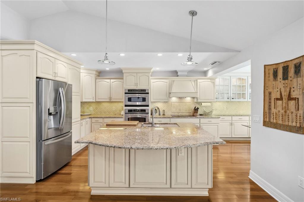 1986 Imperial Golf Course Boulevard Naples, FL 34110 - Photo 10 of 38 a kitchen with kitchen island a counter top space stainless steel appliances and cabinets