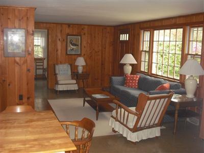 55 Monahansett Road Mashpee, MA 02649 - Photo 3 of 10 a living room with furniture and a chandelier