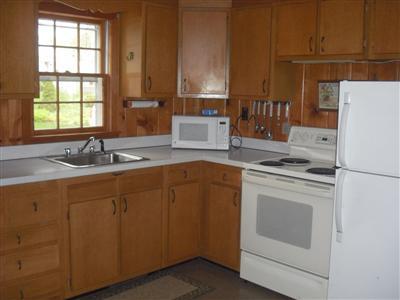 55 Monahansett Road Mashpee, MA 02649 - Photo 5 of 10 a kitchen with a sink cabinets and window