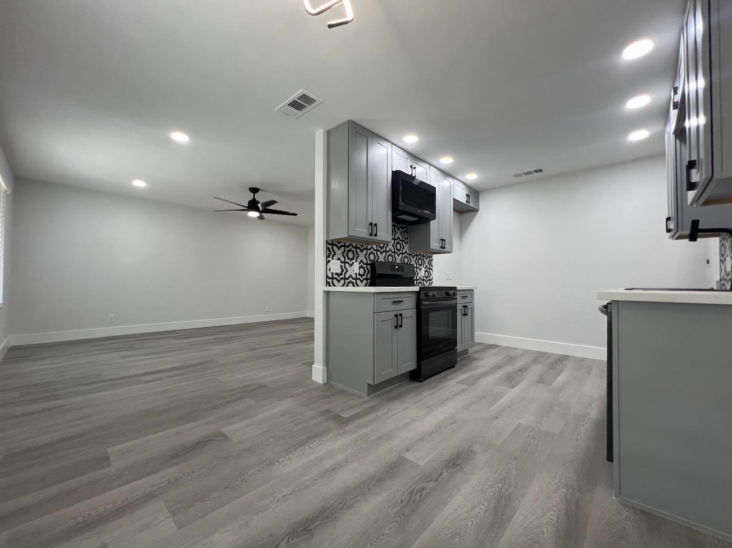 657 West Parlier Avenue, Unit 125 Reedley, CA 93654 - Photo 11 of 25 a kitchen with stainless steel appliances a stove top oven a sink a counter space and cabinets