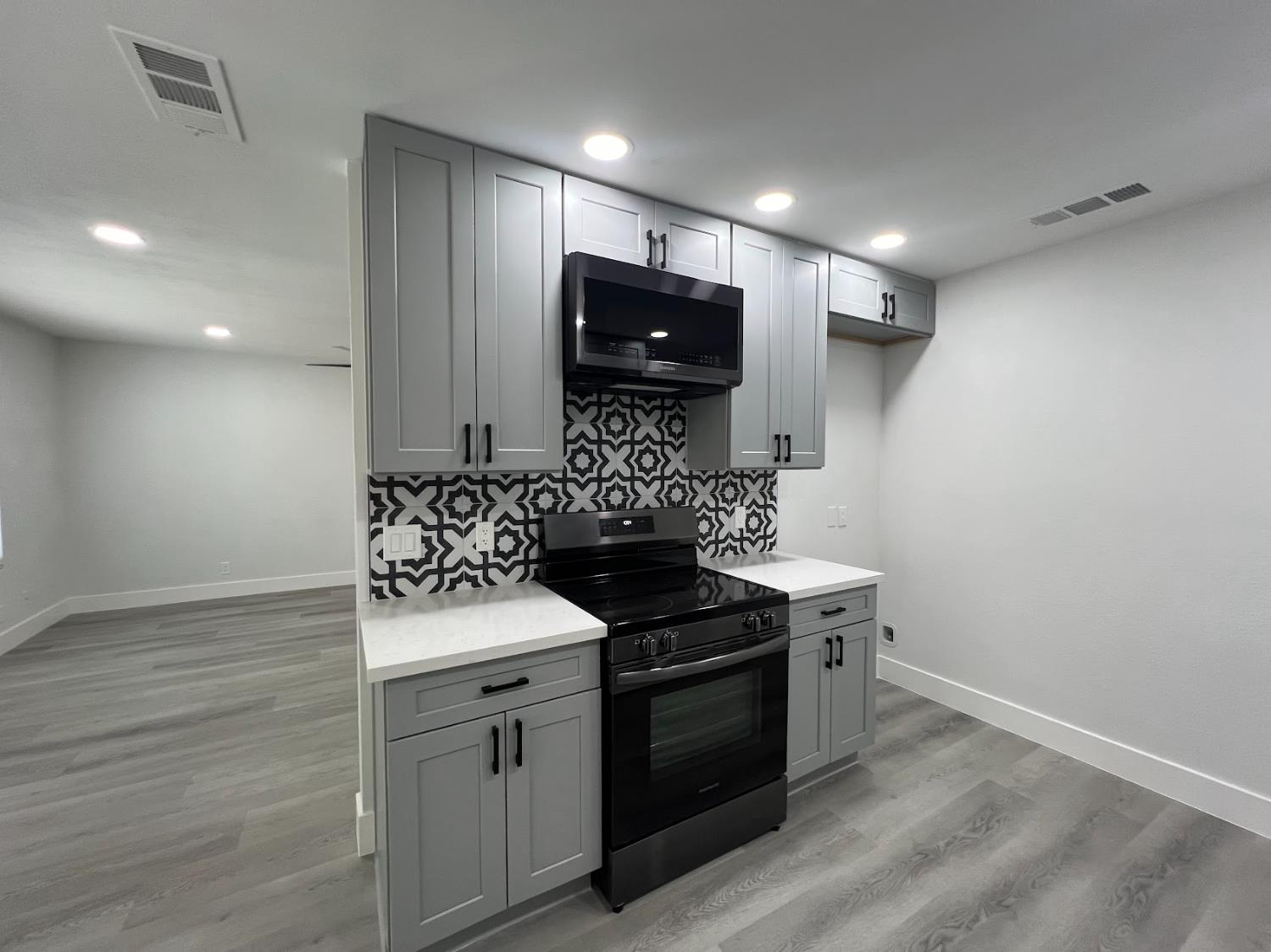 657 West Parlier Avenue, Unit 125 Reedley, CA 93654 - Photo 13 of 25 a kitchen with granite countertop a stove and a sink