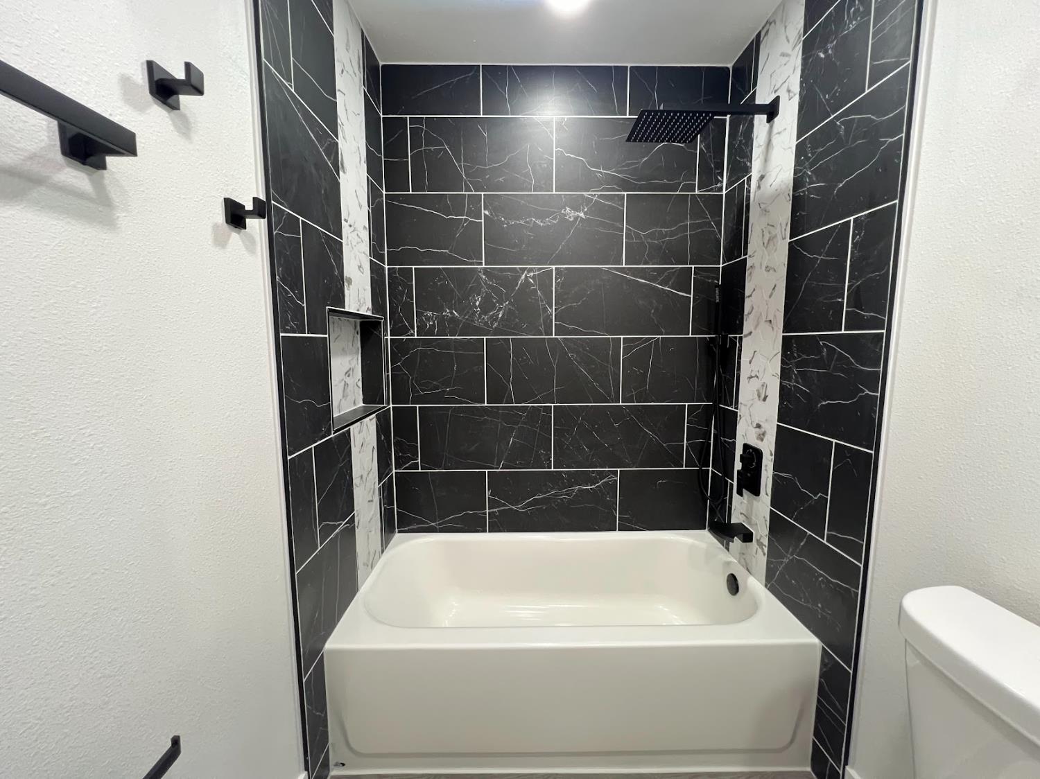 657 West Parlier Avenue, Unit 125 Reedley, CA 93654 - Photo 19 of 25 a bathroom with a bathtub a toilet and a shower