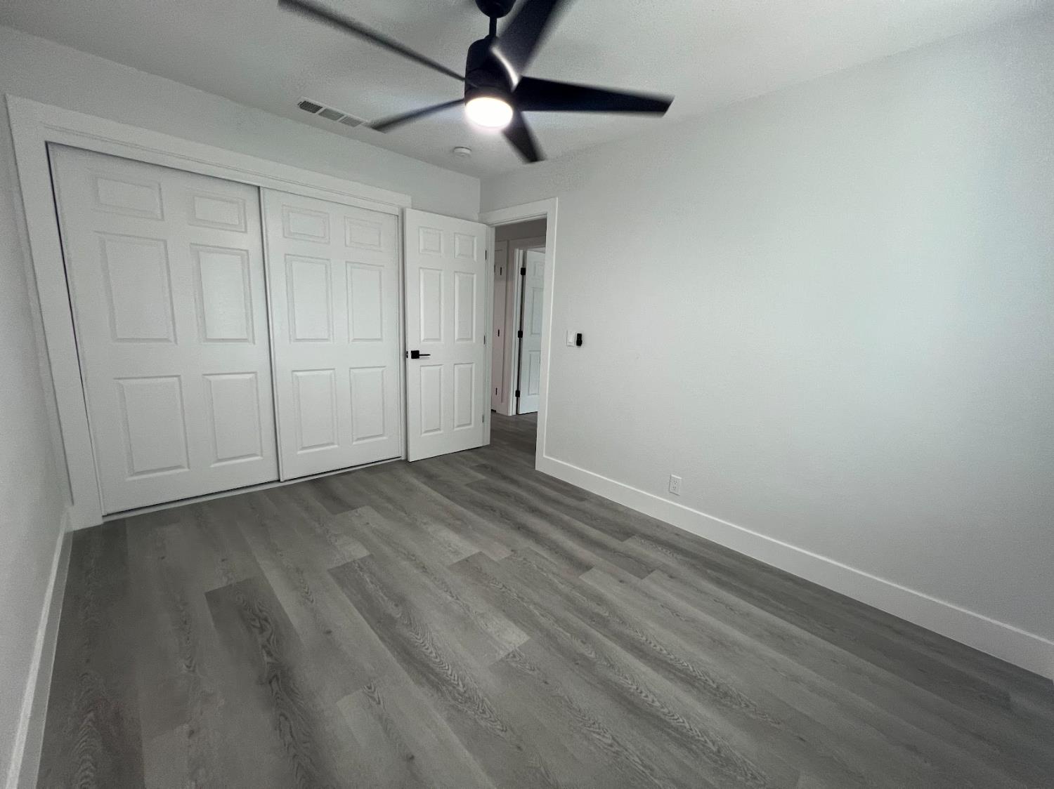 657 West Parlier Avenue, Unit 125 Reedley, CA 93654 - Photo 22 of 25 a view of empty room with wooden floor
