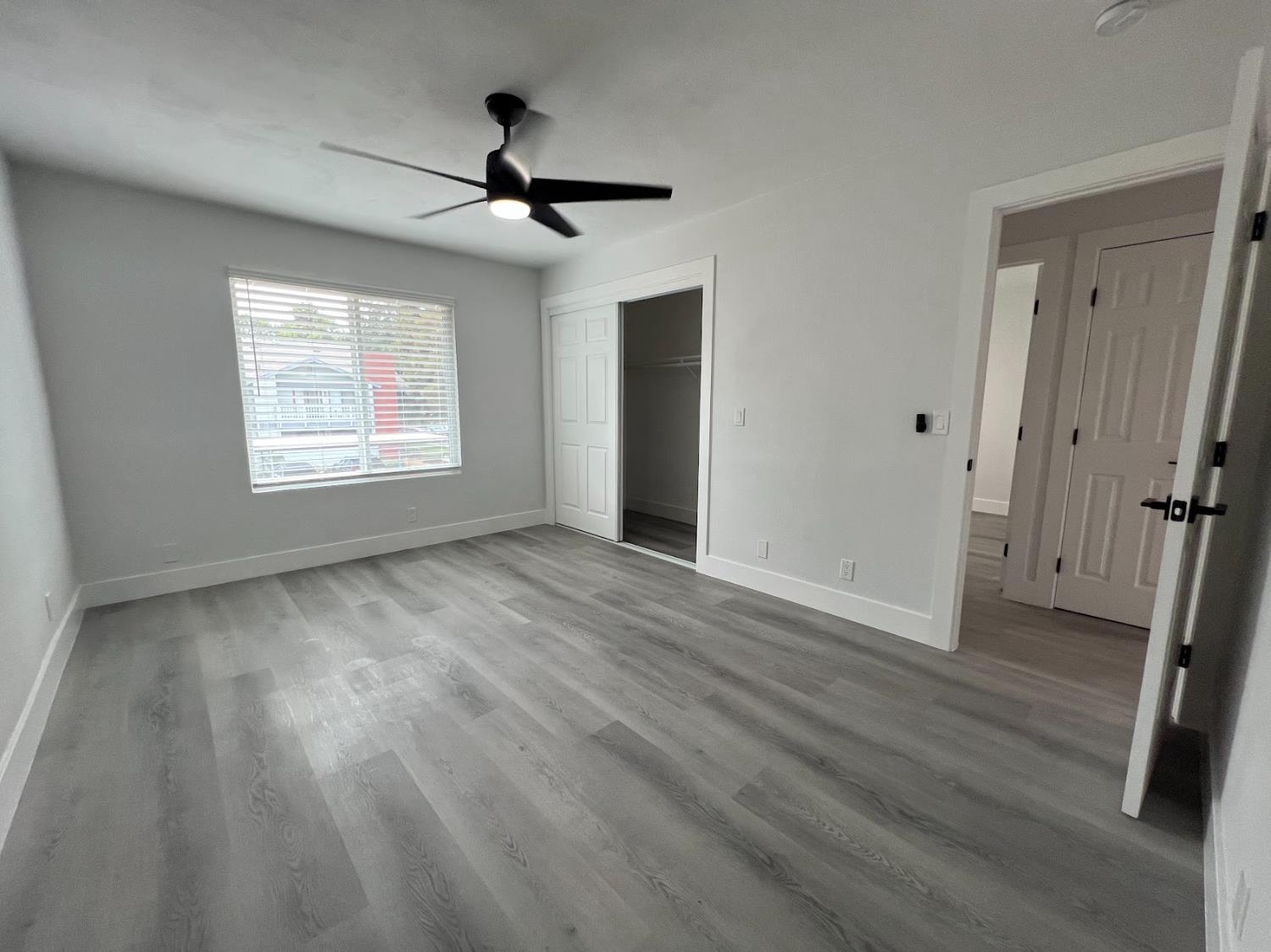 657 West Parlier Avenue, Unit 125 Reedley, CA 93654 - Photo 23 of 25 a view of an empty room with wooden floor and a window