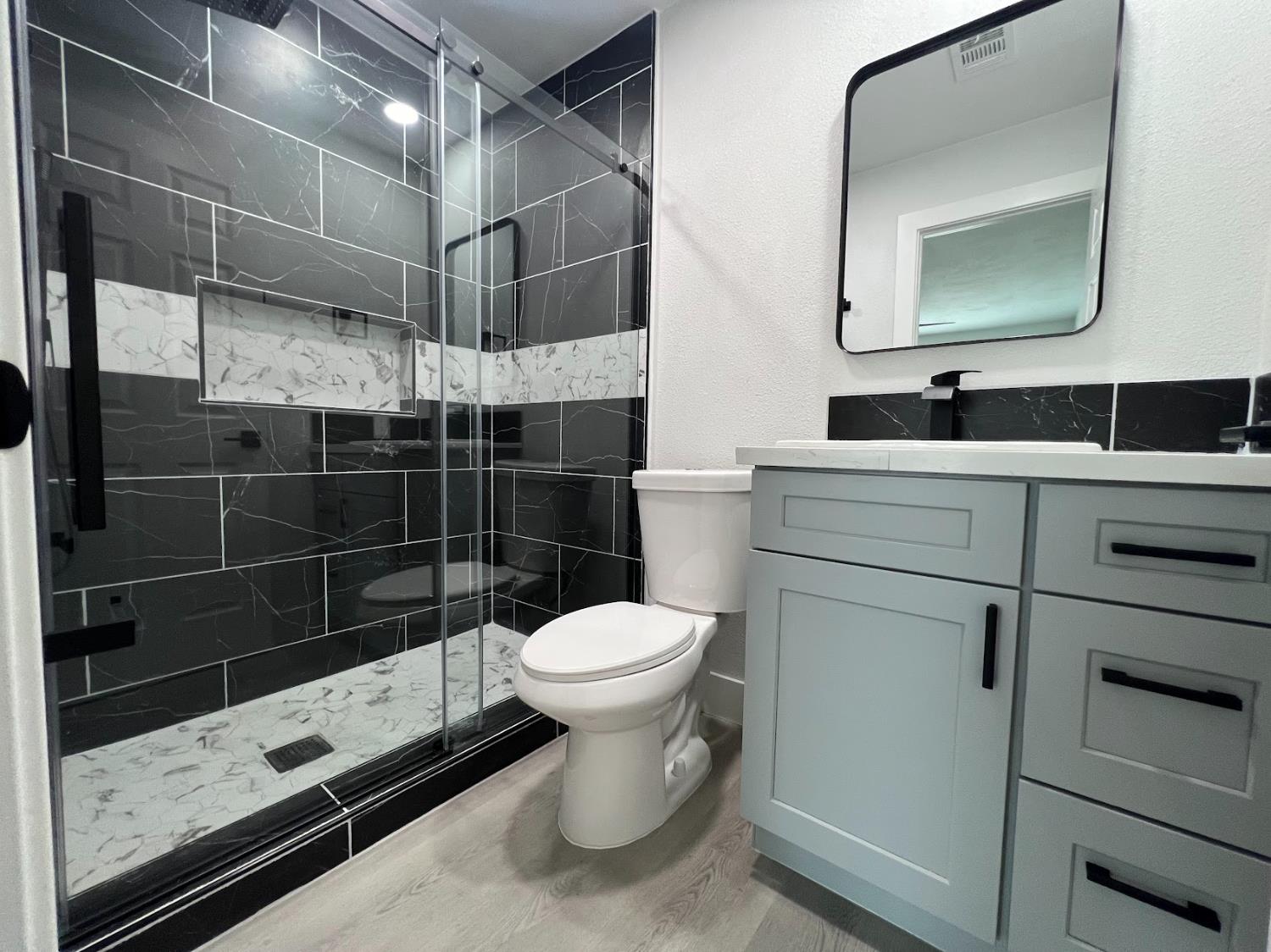 657 West Parlier Avenue, Unit 125 Reedley, CA 93654 - Photo 24 of 25 a bathroom with a sink toilet and shower