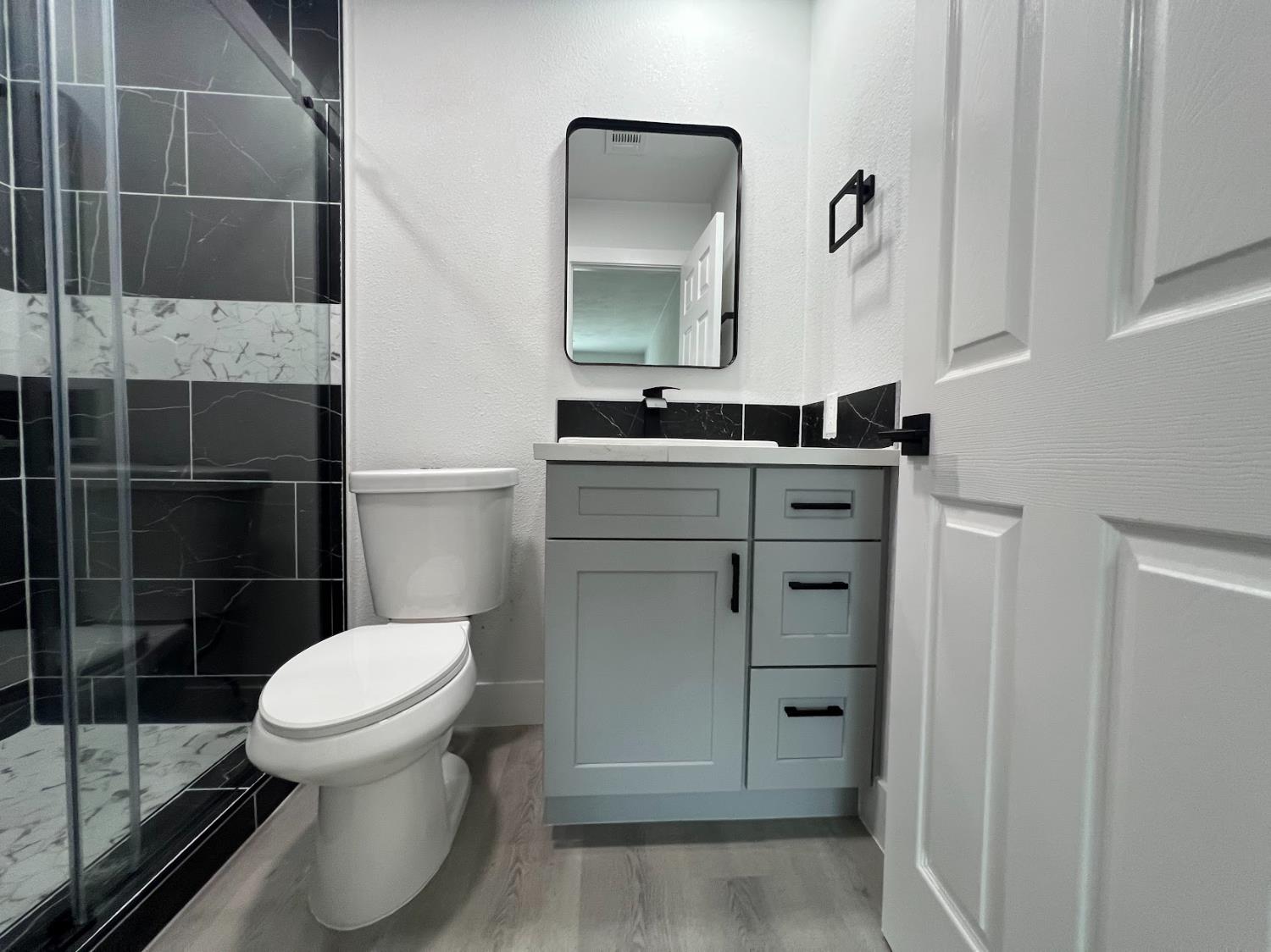 657 West Parlier Avenue, Unit 125 Reedley, CA 93654 - Photo 25 of 25 a bathroom with a toilet a sink and mirror