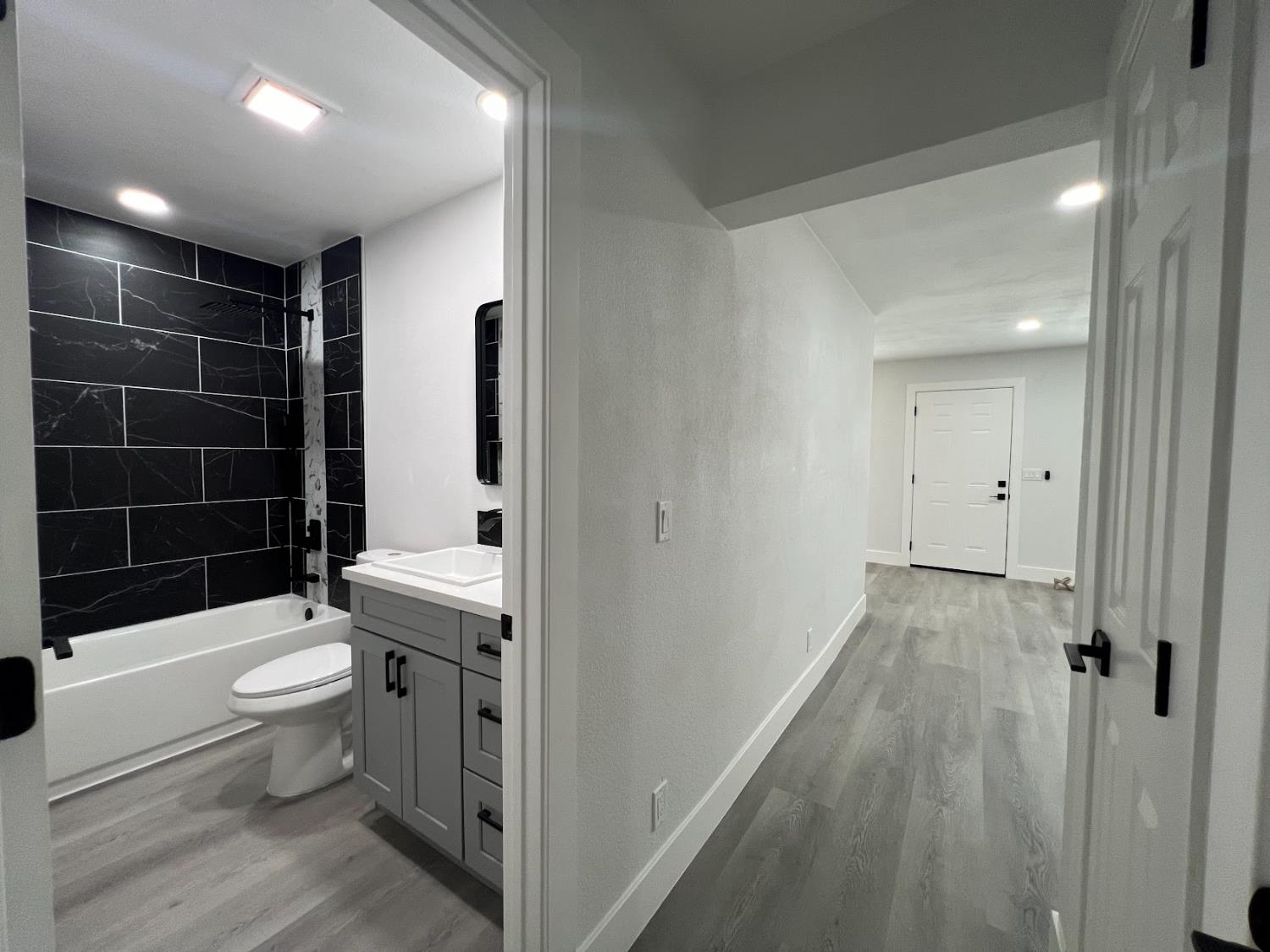 657 West Parlier Avenue, Unit 125 Reedley, CA 93654 - Photo 6 of 25 a bathroom with a sink a toilet a shower and a mirror