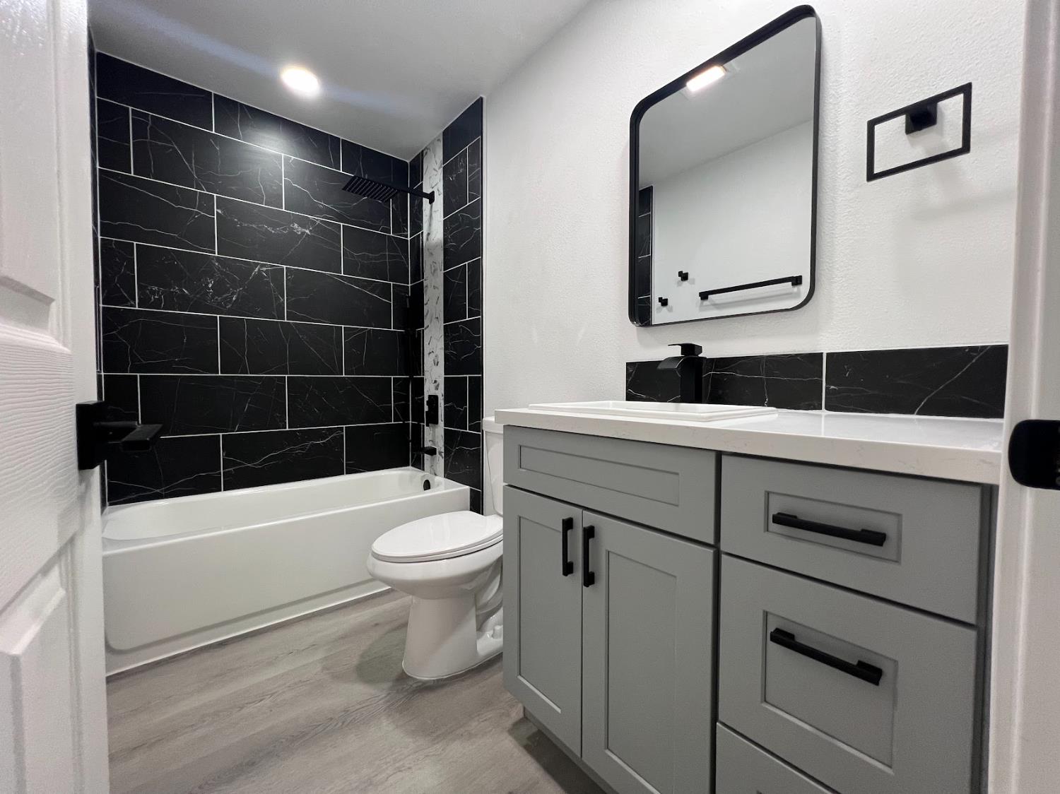 657 West Parlier Avenue, Unit 125 Reedley, CA 93654 - Photo 8 of 25 a bathroom with a sink a toilet and shower