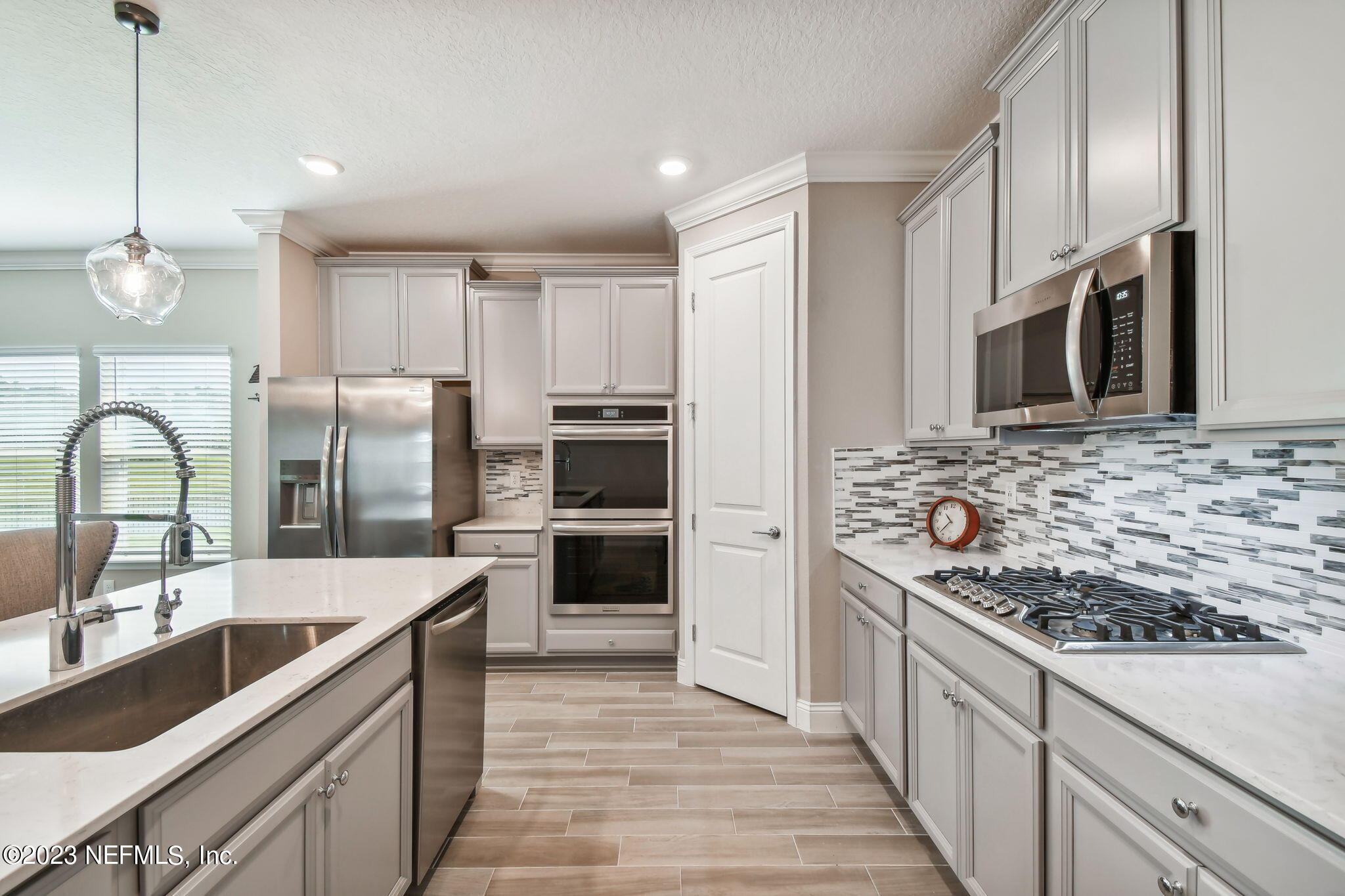 32 Quota Circle St. Johns, FL 32259 - Photo 13 of 79 a kitchen with stainless steel appliances kitchen island granite countertop a sink stove and refrigerator