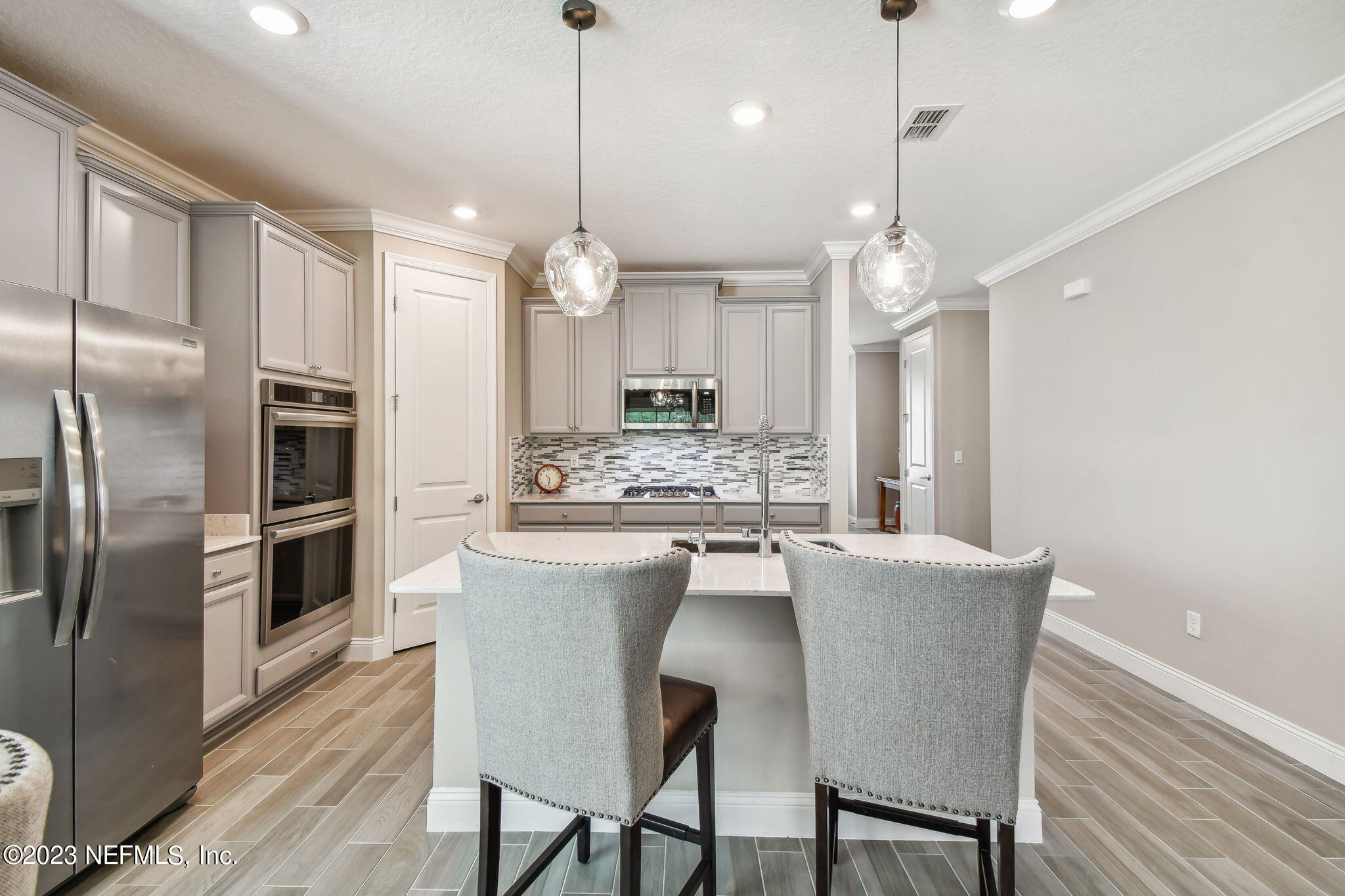 32 Quota Circle St. Johns, FL 32259 - Photo 17 of 79 a kitchen with kitchen island a refrigerator and a stove