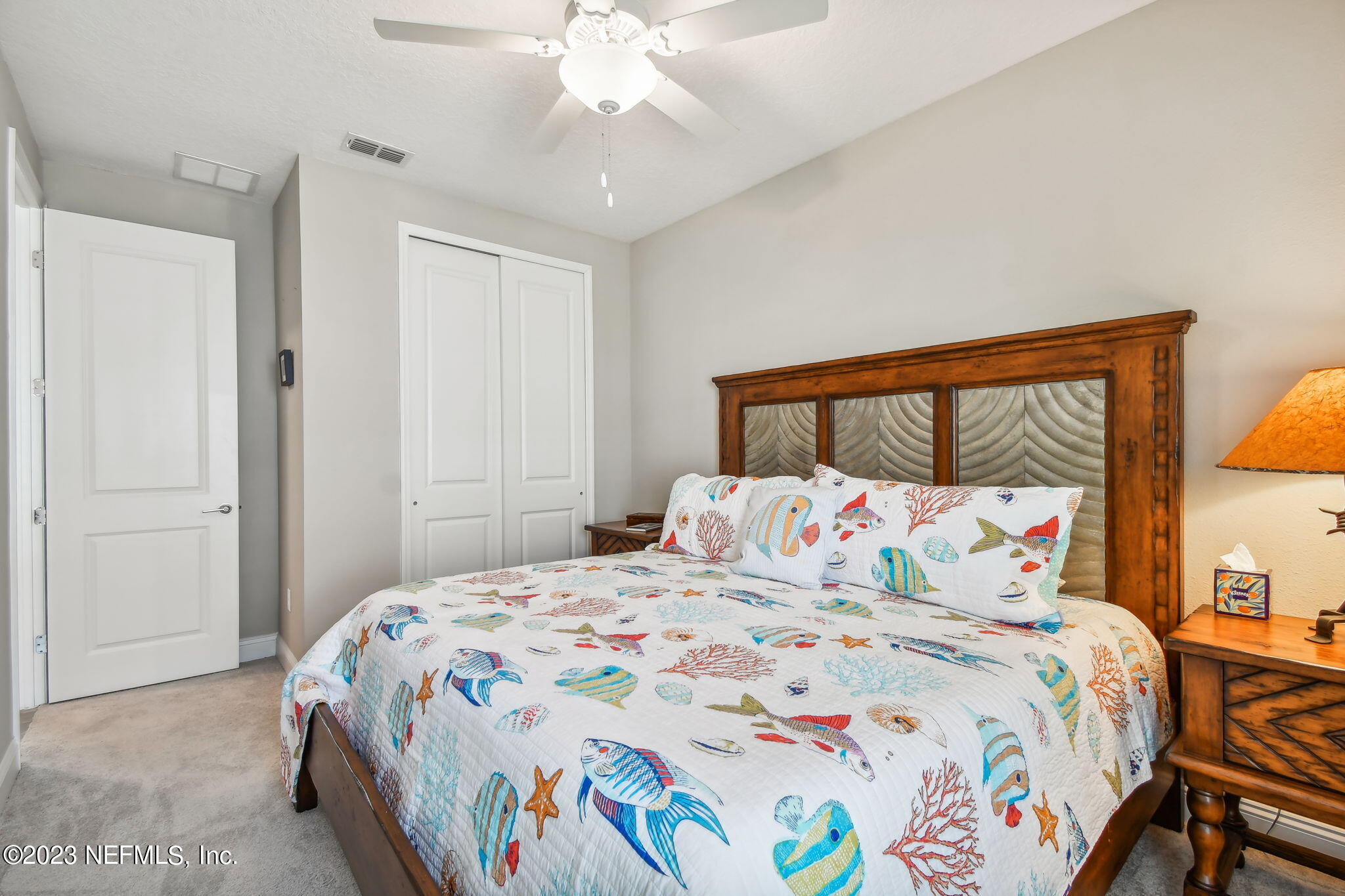 32 Quota Circle St. Johns, FL 32259 - Photo 49 of 79 a bedroom with a large bed and a chandelier