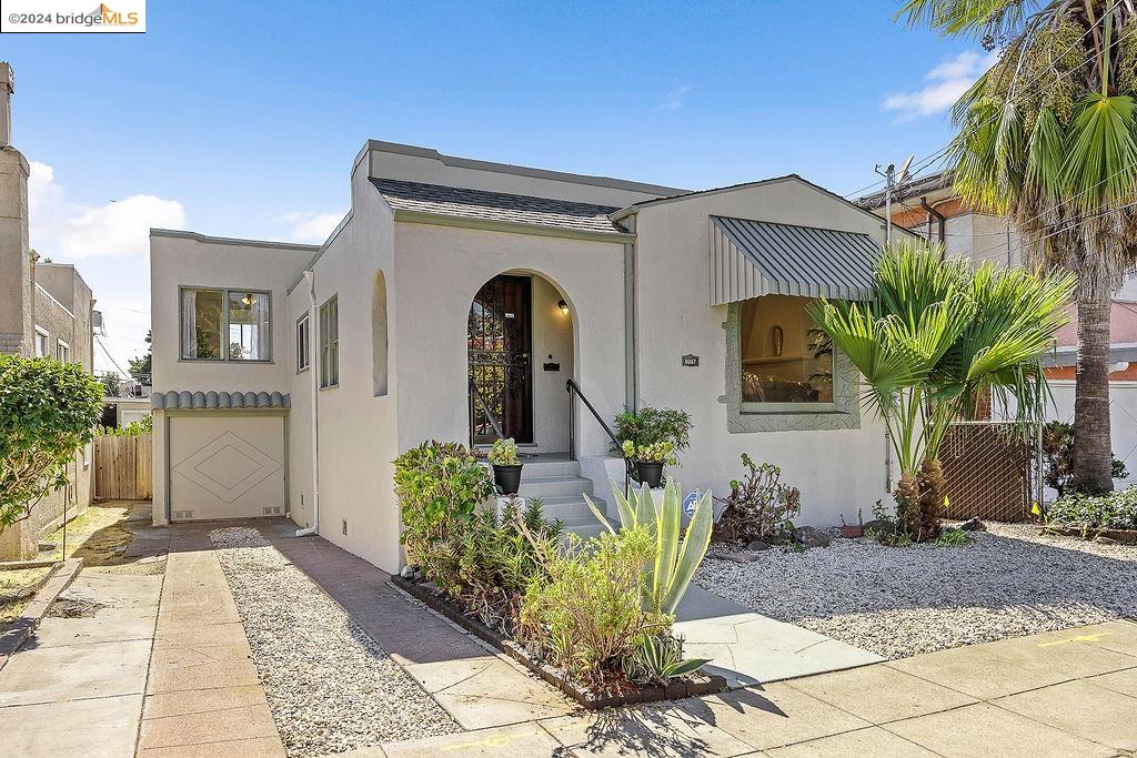 a front view of a house with garden