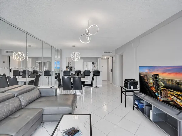 a living room with lots of furniture and a flat screen tv