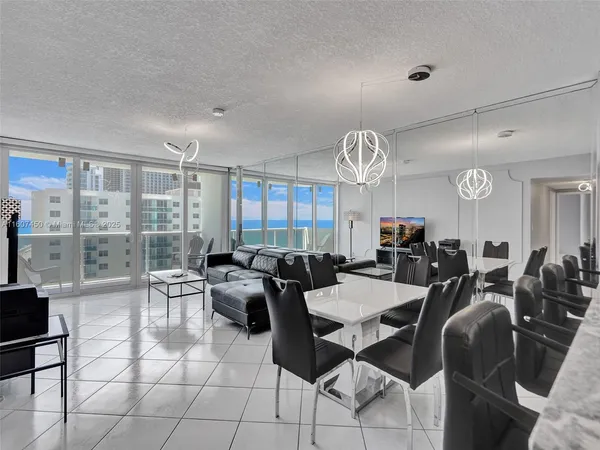 a view of a dining room with furniture and chandelier
