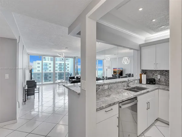 a open kitchen with granite countertop a sink and cabinets