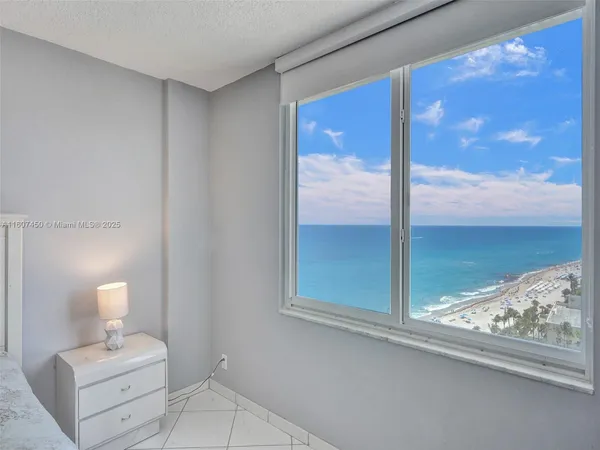 a view of a bedroom with a bed and balcony