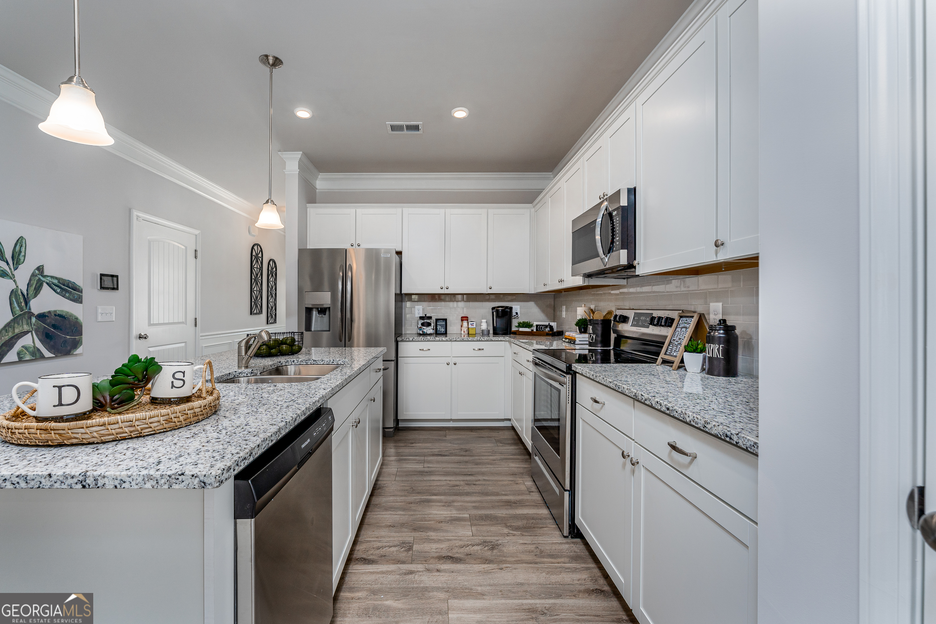 1393 Trellis Court Hampton, GA 30228 - Photo 11 of 25 a kitchen with granite countertop lots of counter top space and stainless steel appliances
