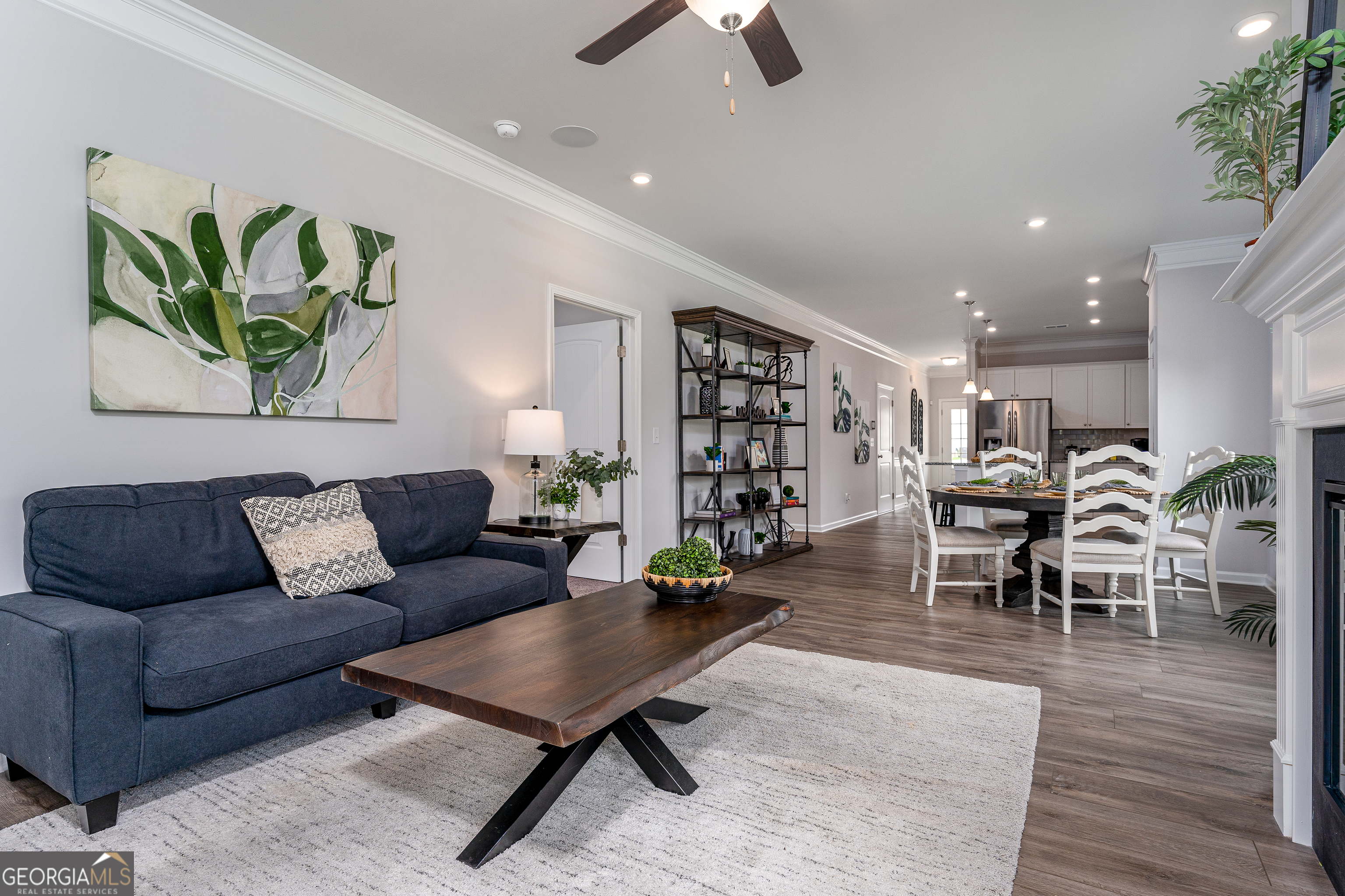 1393 Trellis Court Hampton, GA 30228 - Photo 17 of 25 a living room with furniture kitchen view and a wooden floor