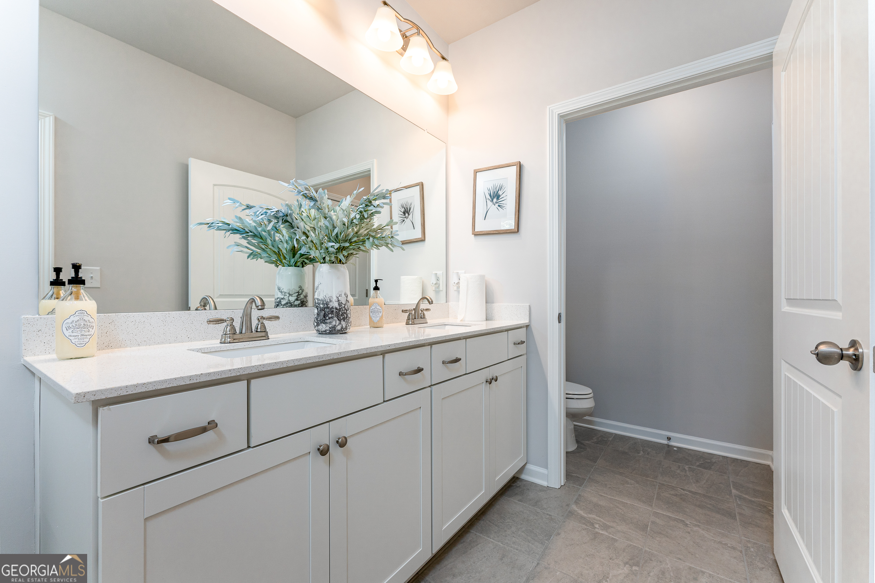 1393 Trellis Court Hampton, GA 30228 - Photo 19 of 25 a bathroom with a sink and a mirror