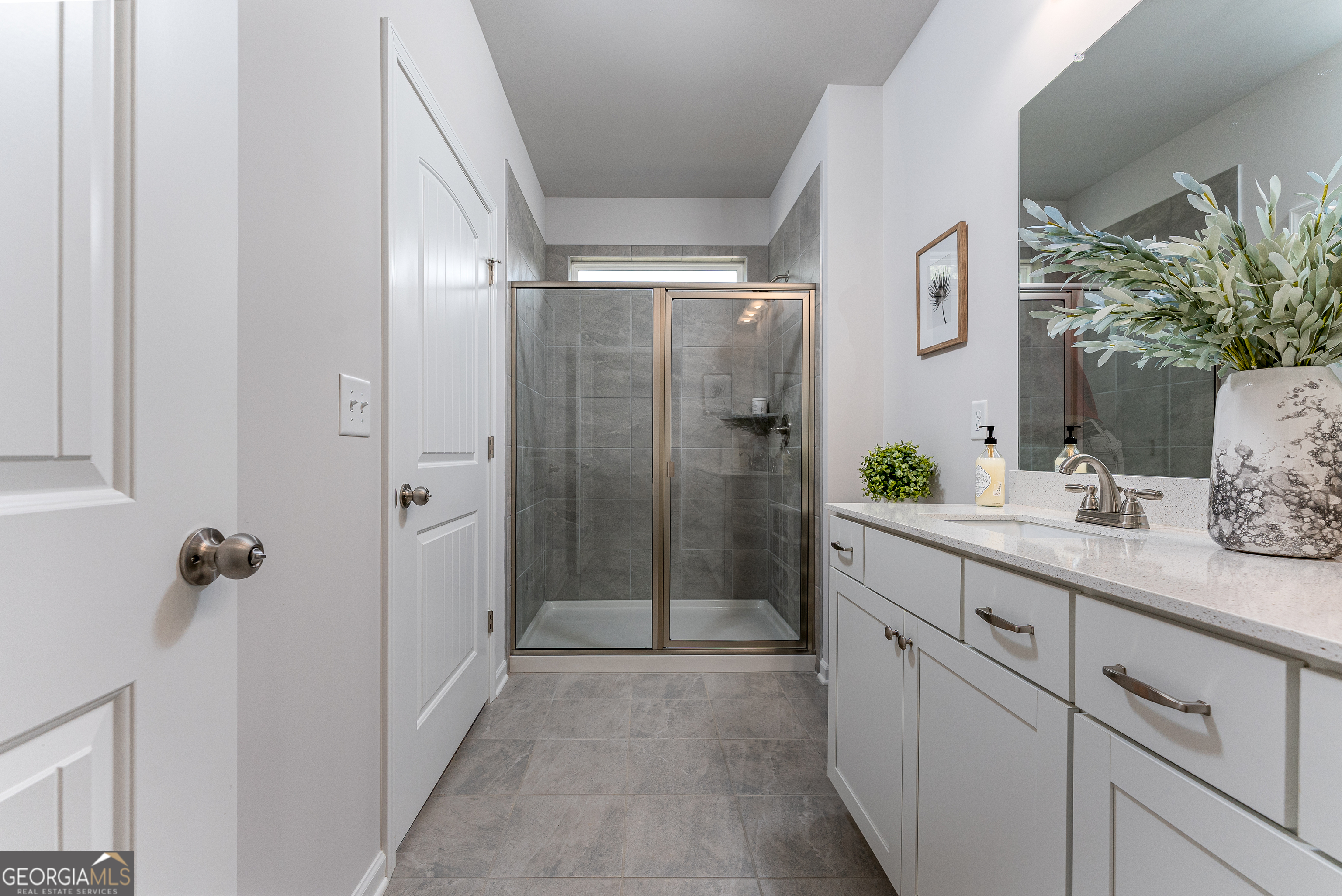 1393 Trellis Court Hampton, GA 30228 - Photo 20 of 25 a bathroom with a shower sink and mirror