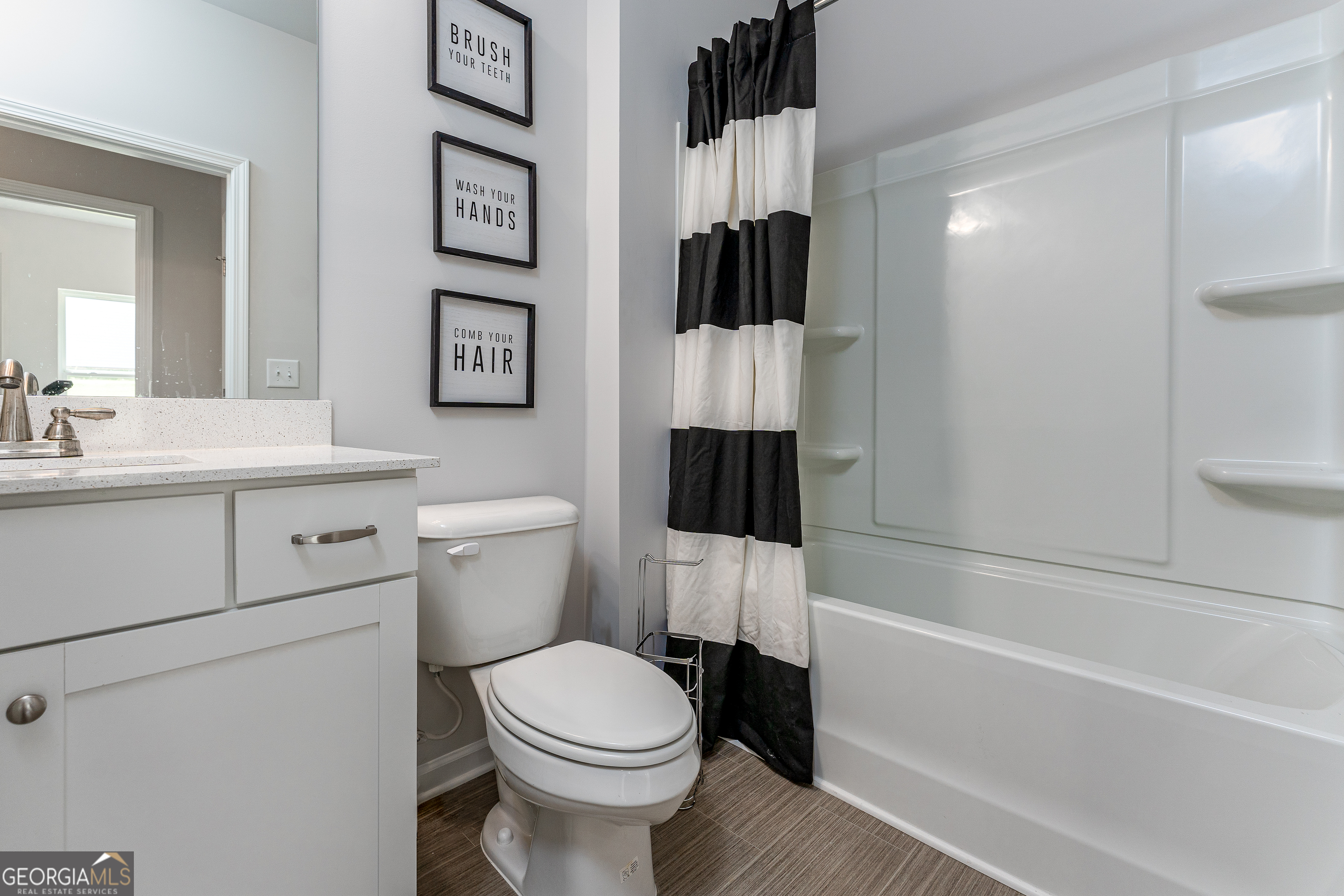 1393 Trellis Court Hampton, GA 30228 - Photo 22 of 25 a bathroom with a sink toilet and shower