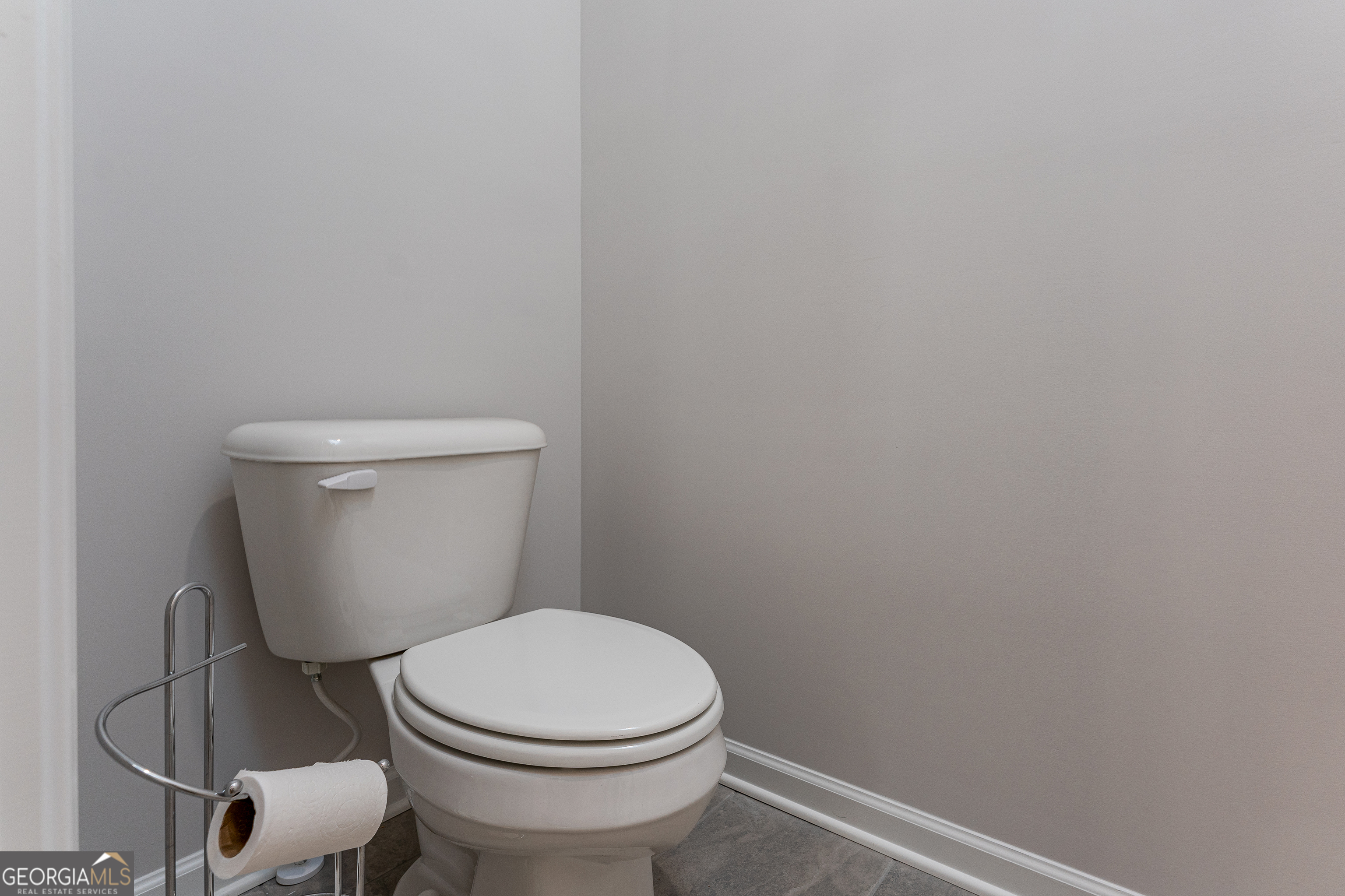 1393 Trellis Court Hampton, GA 30228 - Photo 24 of 25 a white toilet sitting next to a white wall
