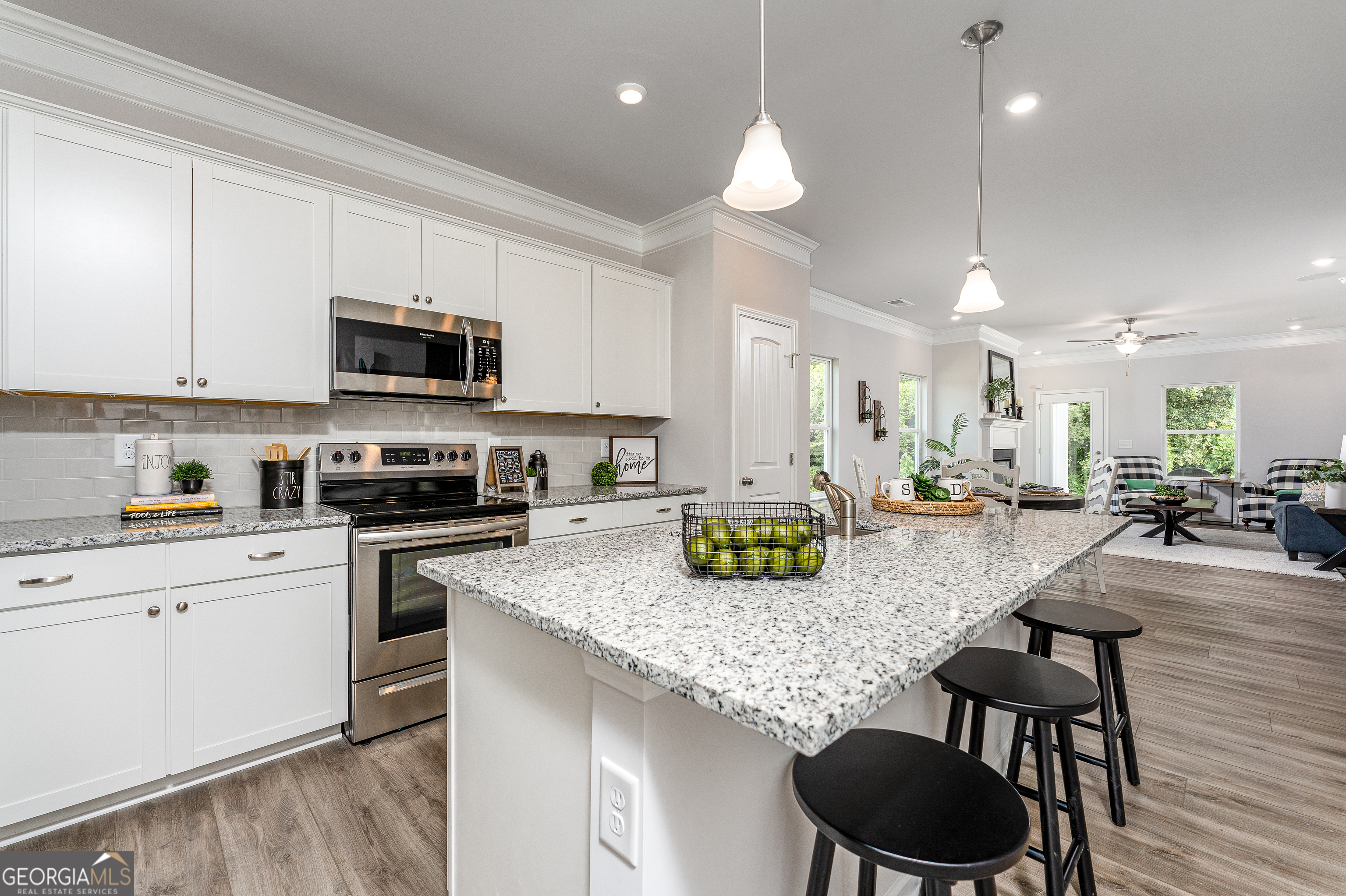 1393 Trellis Court Hampton, GA 30228 - Photo 7 of 25 a kitchen with sink a stove and chairs