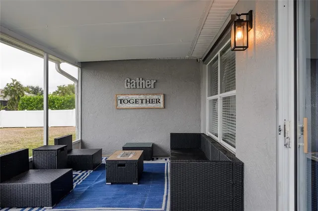 a view of a livingroom with workspace and a window