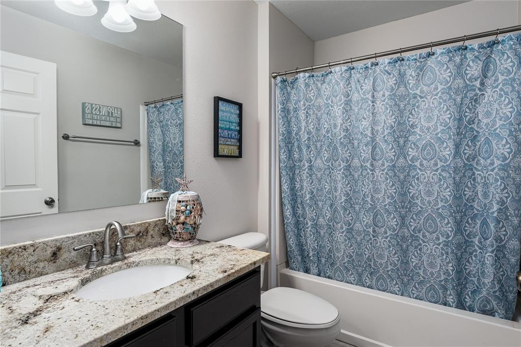 11493 Walden Loop Parrish, FL 34219 - Photo 17 of 30 a bathroom with a granite countertop sink a toilet and a mirror