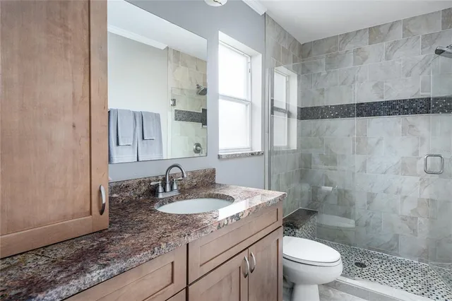 a bathroom with a sink toilet and shower