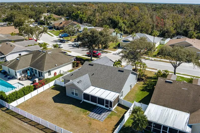 an aerial view of a house with a yard