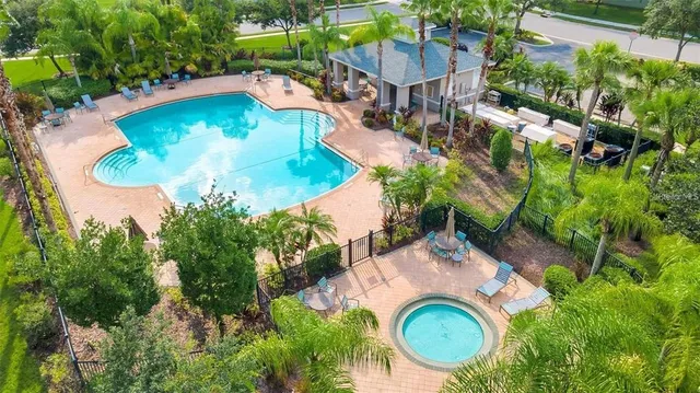 an aerial view of a house with yard swimming pool and outdoor seating