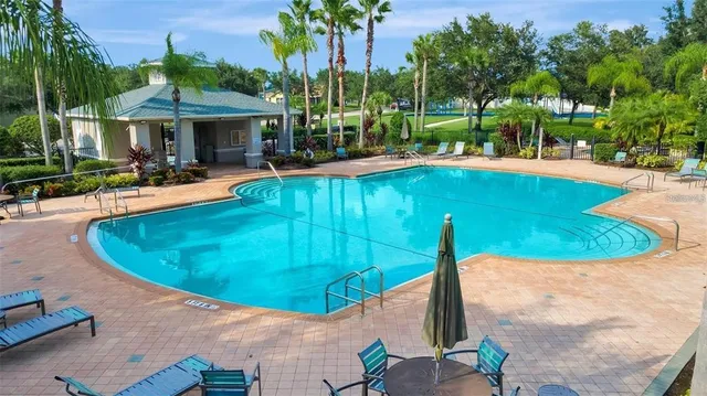 an outdoor space with swimming pool and furniture