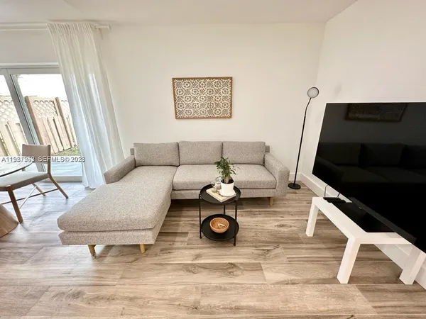 a living room with furniture and a rug
