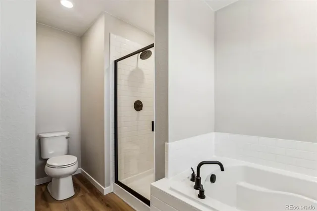 a bathroom with a toilet and a tub