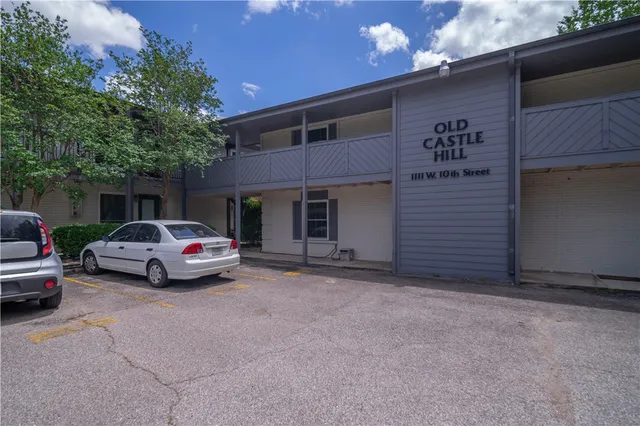 a view of street with parked cars