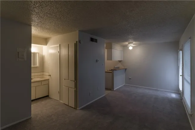 an empty room with closet and mirror