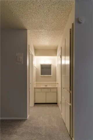 a white toilet and tub sitting next to a bathroom sink