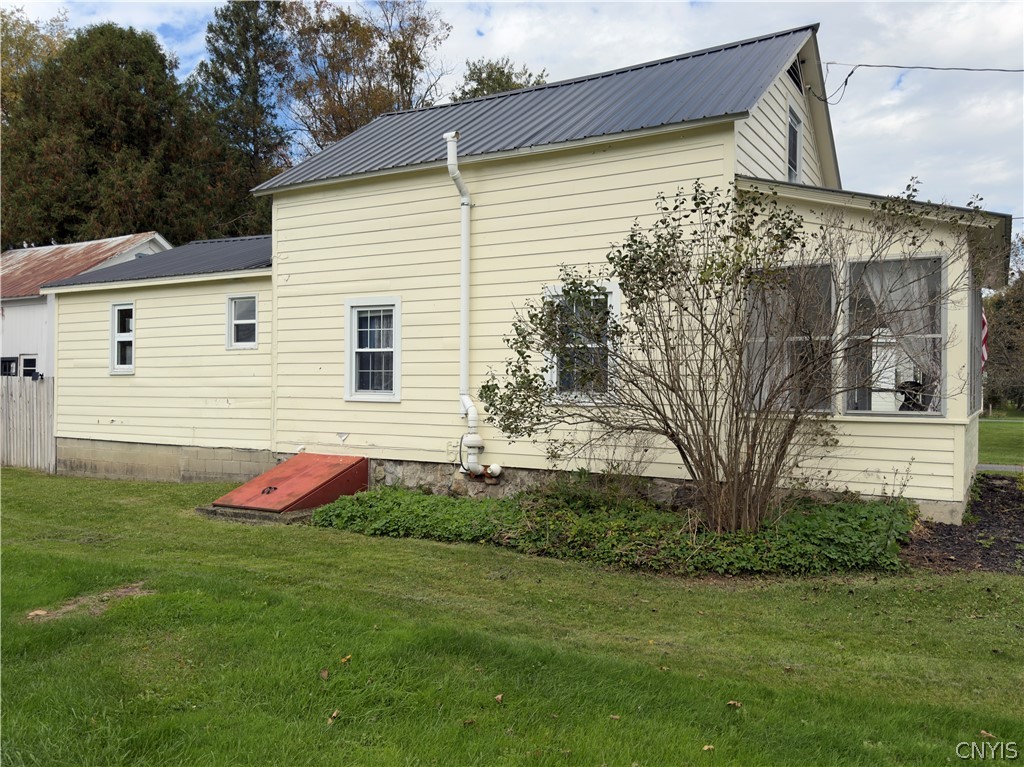 7468 Willey Road Hamilton, NY 13332 - Photo 3 of 19 Classic horizontal siding and a durable metal roof define the exterior of this country home.